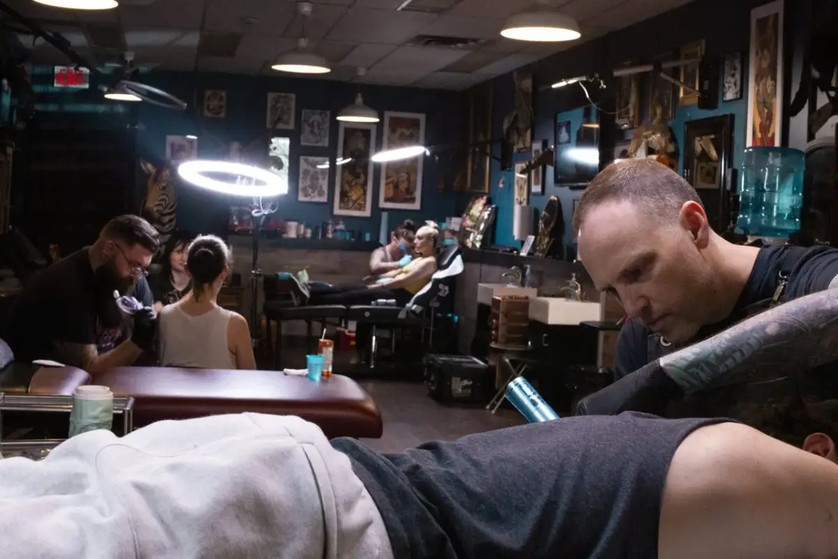 Professional Calgary tattoo artist Dan Cameron working on custom traditional tattoo design